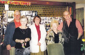 A smiling group pose in front of the sadly shuttered lounge bar