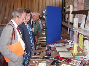 Pam is discusssing the exhibits with the Mayor. 